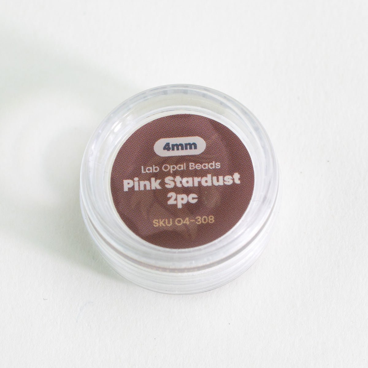 Container of pink opal beads labeled 'Pink Stardust 2pc' on a white background
