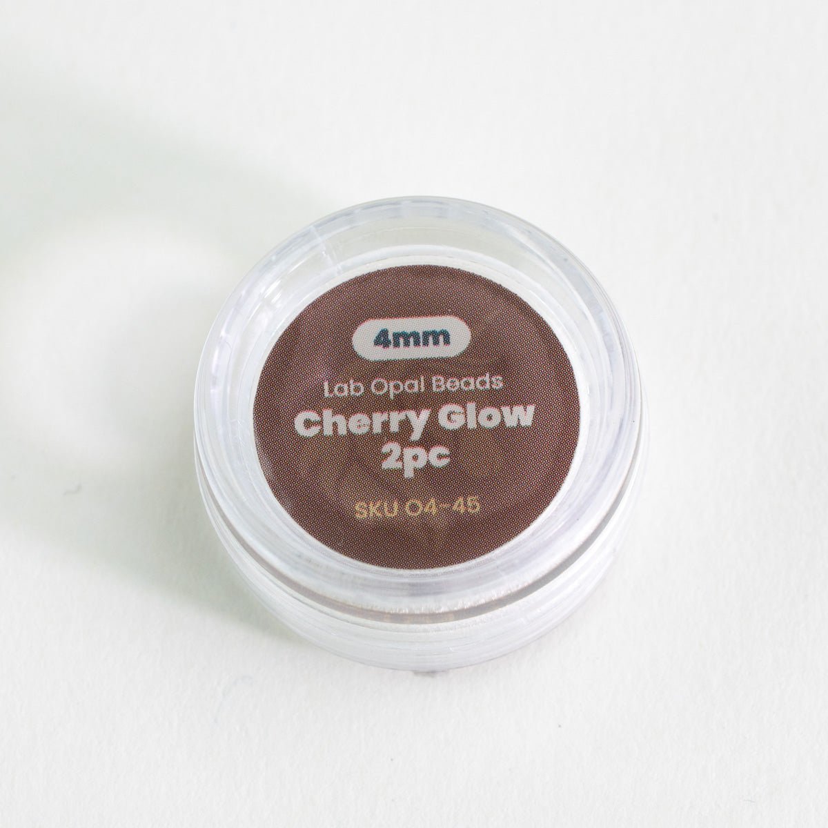 Container of Lab Opal Beads with 'Cherry Glow' label on a white background