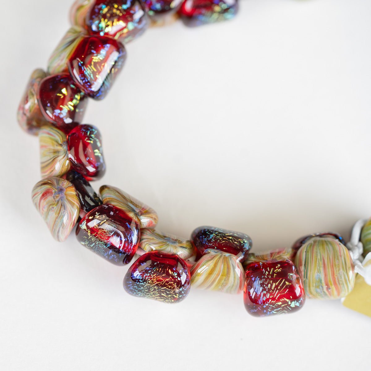 Close-up of a colorful beaded necklace on a white background