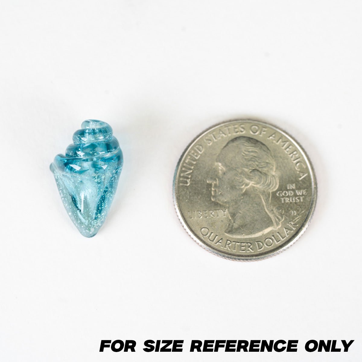 Blue crystal seashell bead next to a U.S. quarter for size reference on a white background