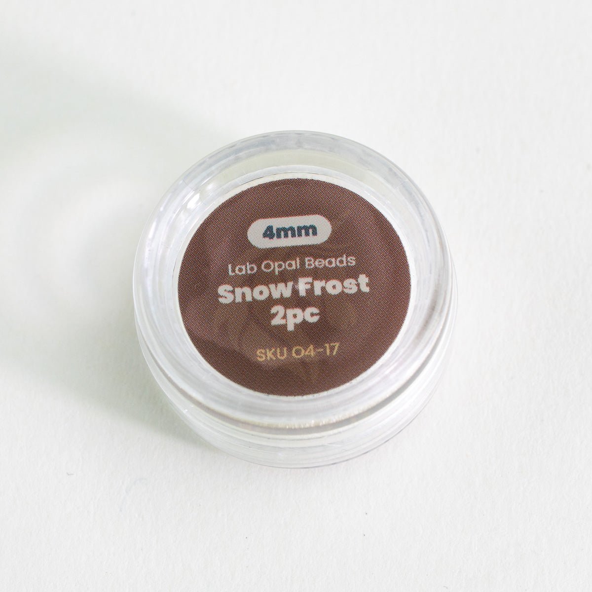 Small container labeled '4mm Lab Opal Beads Snow Frost 2pc' on a white background