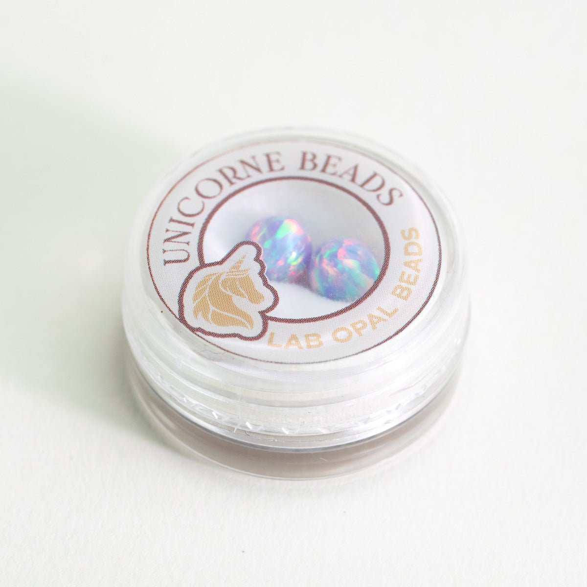 Jar of Unicorne Beads Lab Opal Beads on a white background