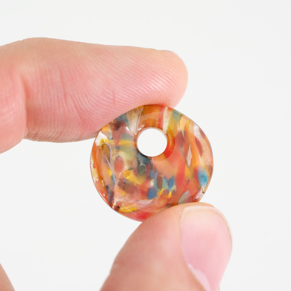 Small Bird of Paradise halo disk glass bead with multicolor layered pattern
