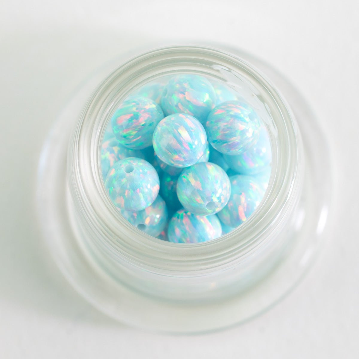 Close up of aqua Glacier Tide opal glass beads used in the DIY ear wire kit