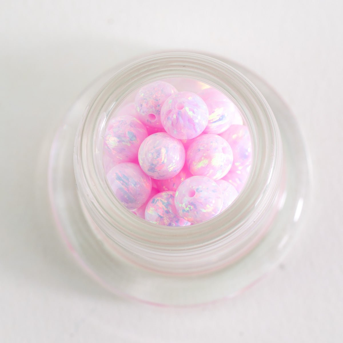 Close up of Pink Nova opal glass beads with pink color and iridescent sparkle