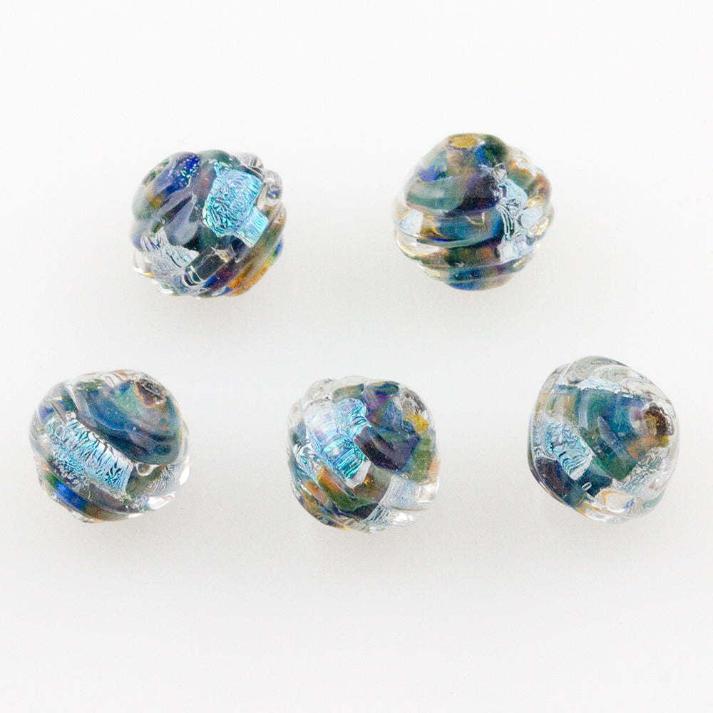 Five coconut shaped glass beads from Unicorne beads featuring an array of colors and two holes you for making bracelets and other jewelry crafts. 