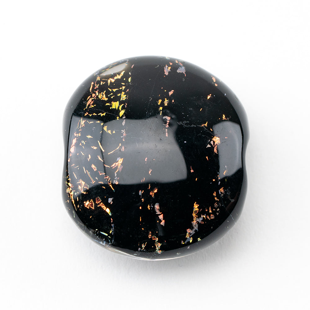One large glass jewelry bead black in color with a rainbow, dichroic feature.  Bead has two holes in each side used for jewelry making 