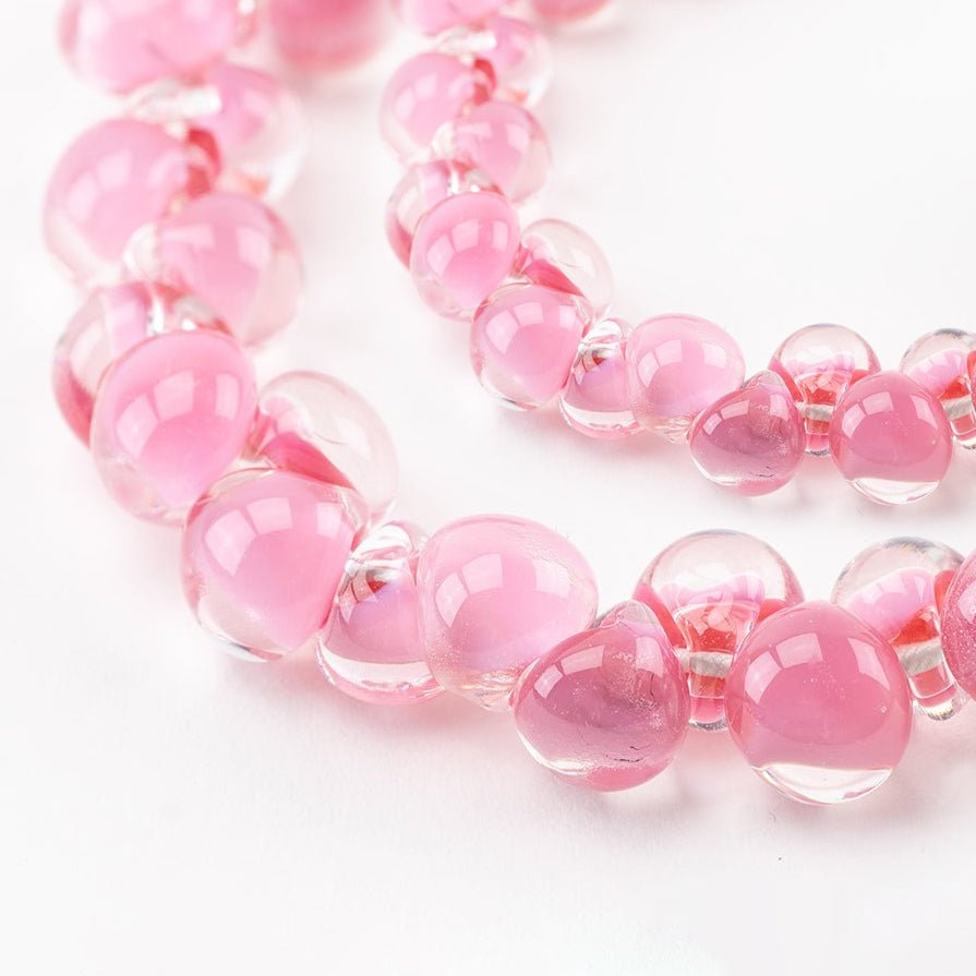 Pink rose teardrop glass bead strands together as a grouping