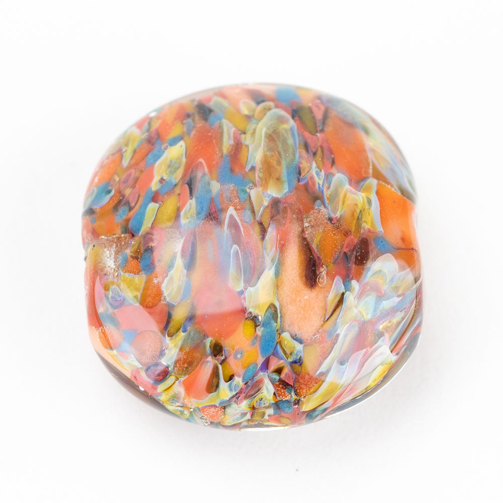 One large glass jewelry bead made up of multiple colors of glass including, orange, yellow, blue, red, and white. The large glass bead has two hole on either end to be used for stringing on jewelry works.