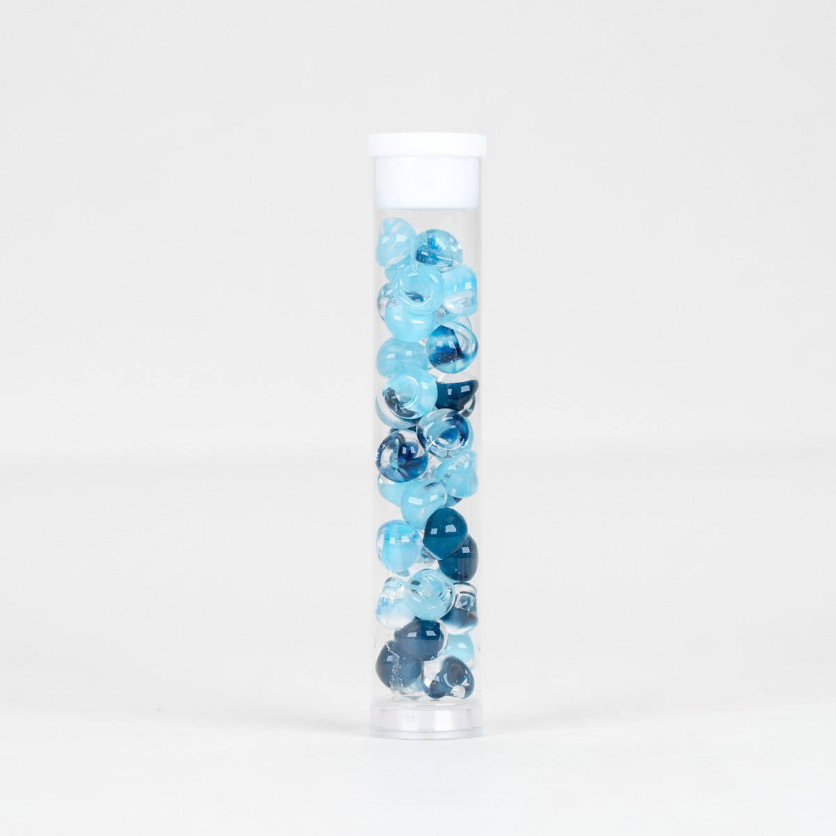 A clear plastic cylindrical tube with a white screw cap, filled with marbled blue and white decorative glass beads, shown on a seamless white background.