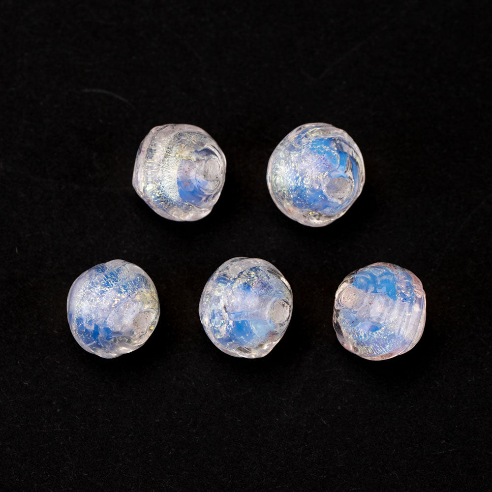 Five coconut shaped glass beads from Unicorne Beads feautirng a light blue, dichroic coloring. Each bead has a hollow center to be used for bracelets, necklaces, and other jewelry projects.