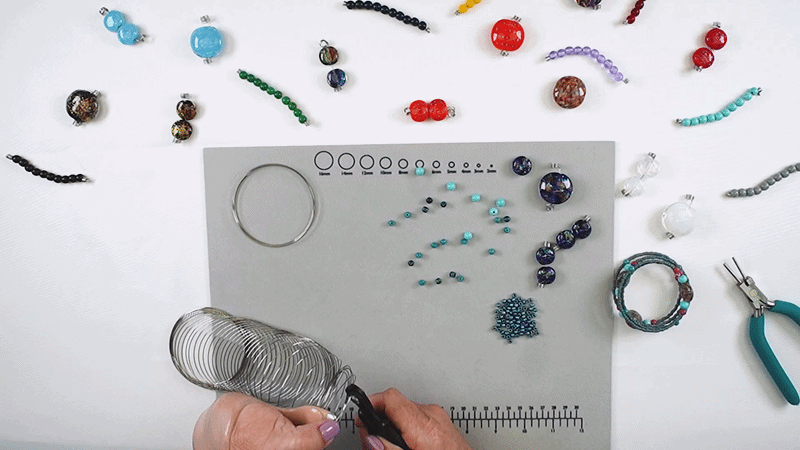 Hands cutting memory wire with memory wire cutter