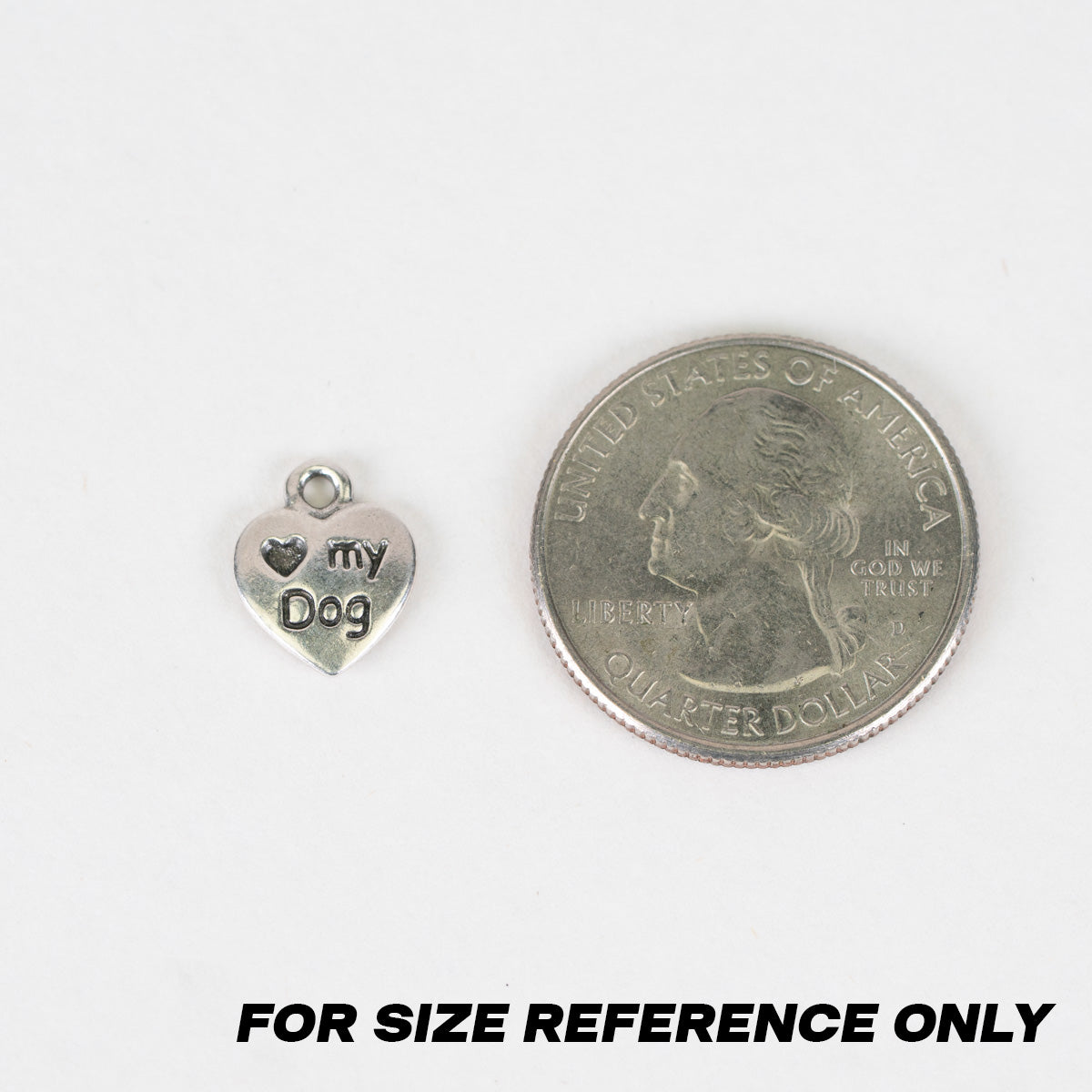 A small silver heart-shaped charm engraved with 'my Dog' and a heart symbol, shown next to a US quarter coin for size reference on a white background with the text 'FOR SIZE REFERENCE ONLY' at the bottom.