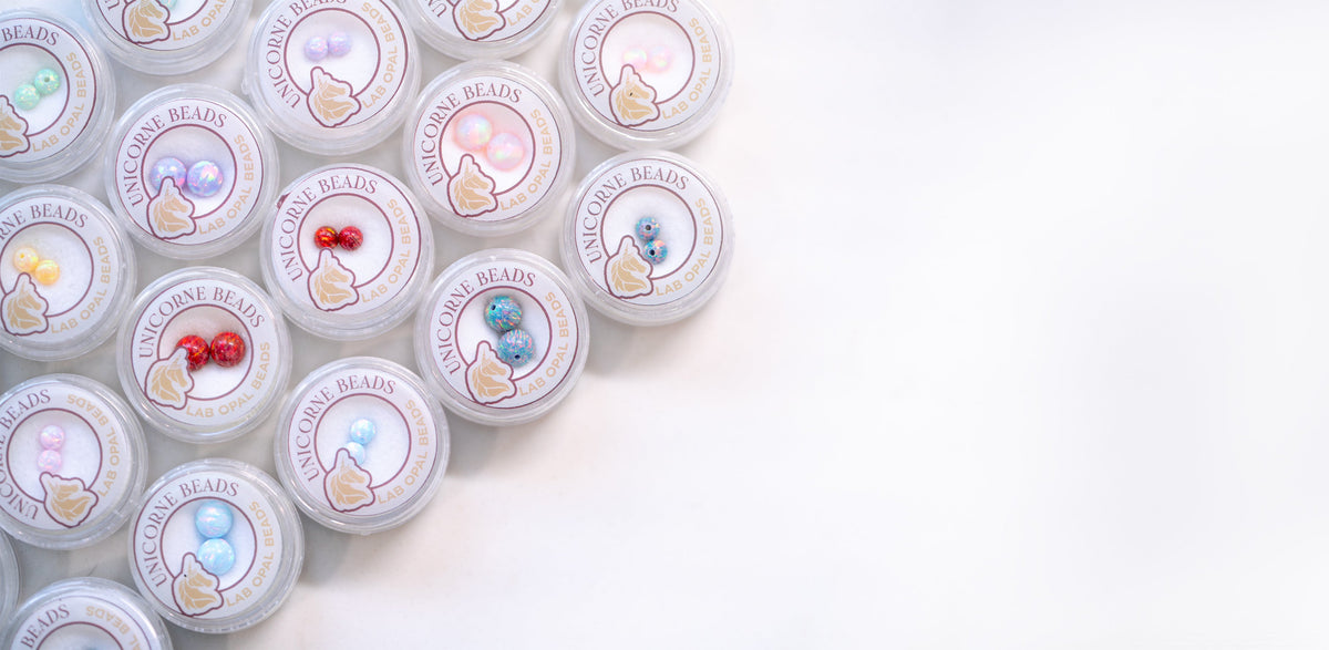 An assortment of opal bead pairs by Unicorne beads in various sizes and colors
