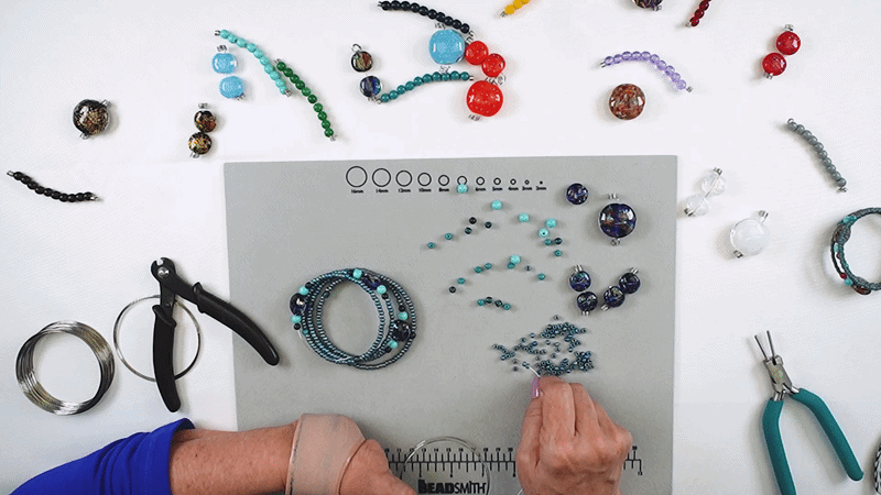 Adding blue seed beads to memory wire bracelet