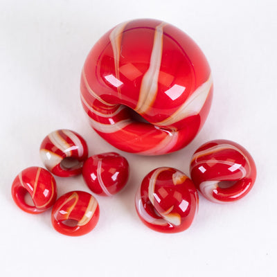 A collection of jumbo, regular, and mini teardrop glass beads handblown by Unicorne Beads