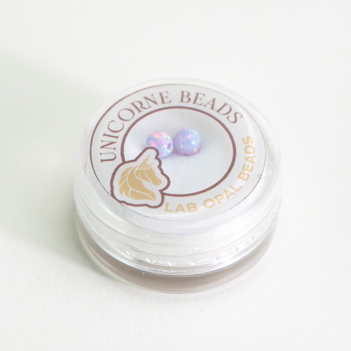 Unicorne Beads packaging with two purple beads inside