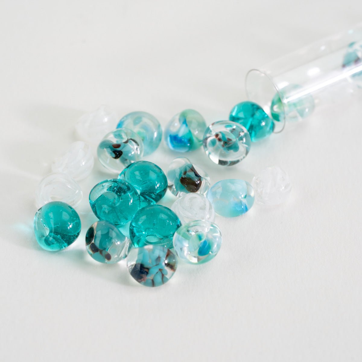 Handcrafted lampwork teardrop beads in aqua blue, teal, and clear ocean tones