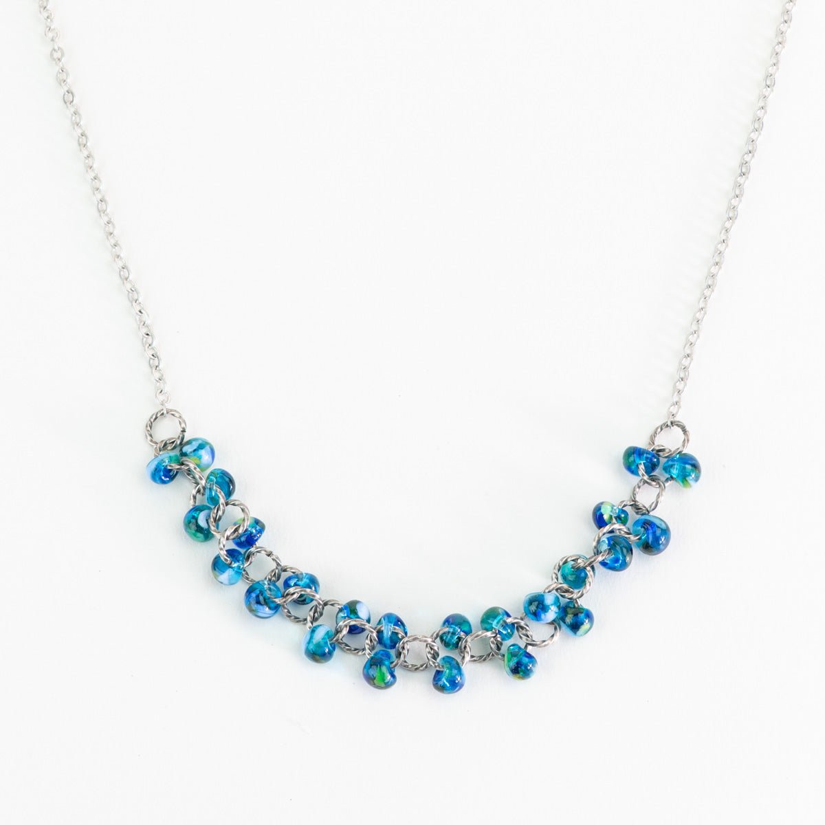 Azure Blue teardrop cluster necklace featuring transparent glass beads