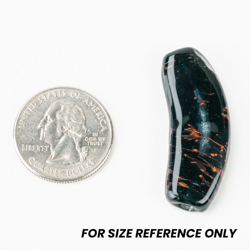 Unicorne Beads banana bead next to a quarter for size reference