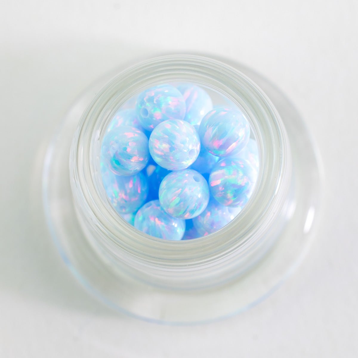 Close up of Blue Whisper opal beads with soft blue and iridescent tones