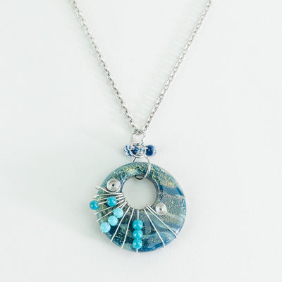 Handmade deep lagoon halo swirl necklace with wire wrapped glass focal