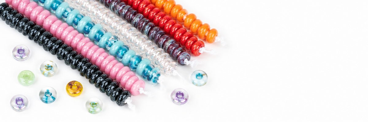 Desktop banner featuring colorful handmade lampwork glass donut bead strands with 25 beads each on a white background.