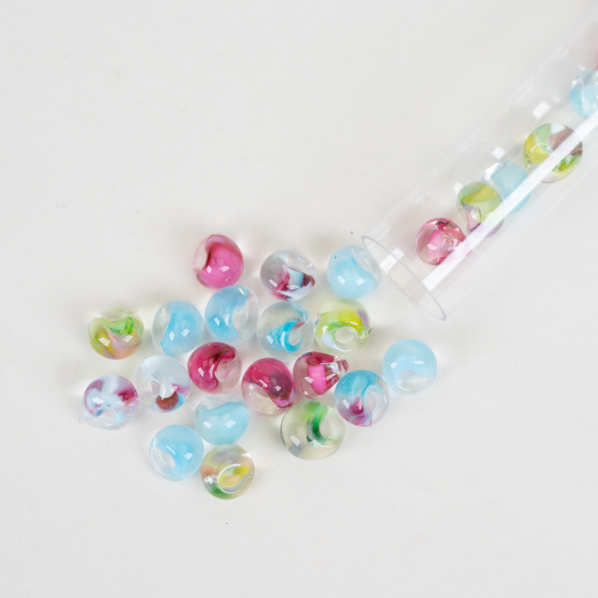 Mini Blossom Garden Teardrop Beads scattered on a plain white background