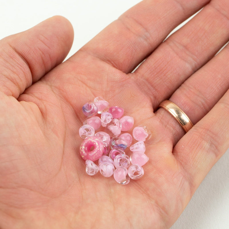 Elegant pink glass beads arranged for jewelry making to raise awareness for breast cancer