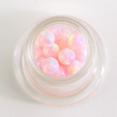 Close up of Pink Stardust opal beads with soft iridescent tones