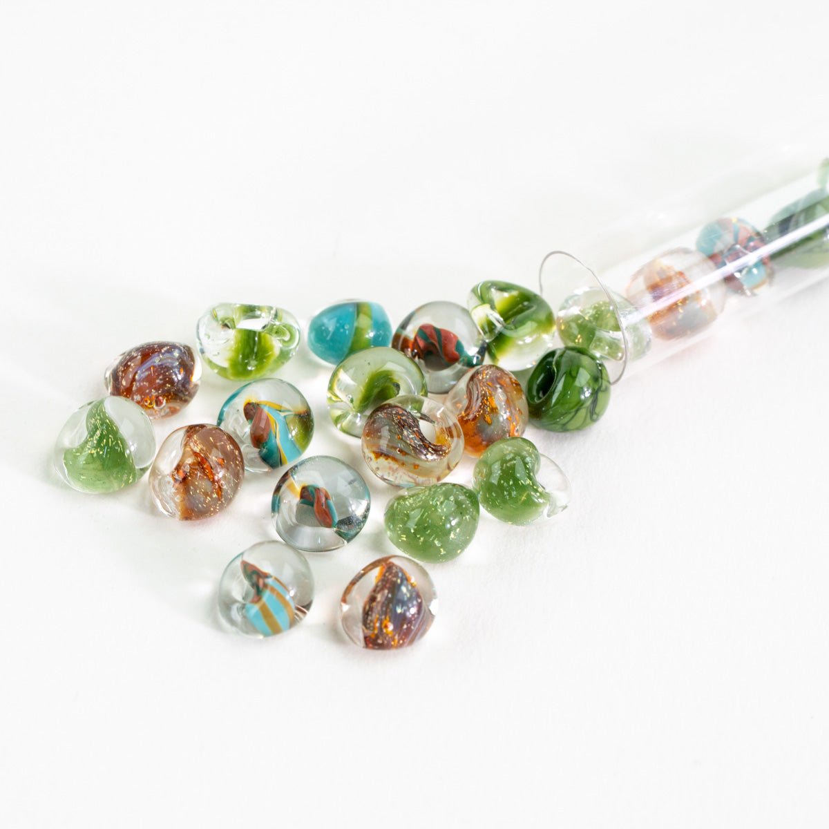 Organic earth tone glass bead palette with moss green, amber, and transparent beads
