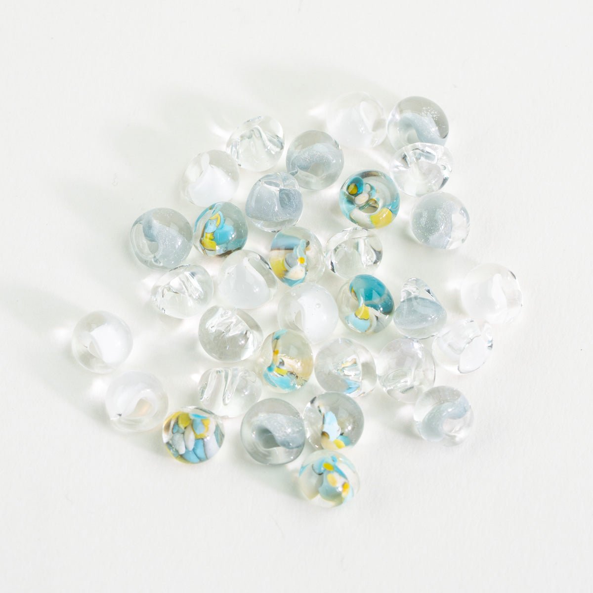Whispering Sky palette teardrop glass bead tube with clear, pale blue, and white handmade beads