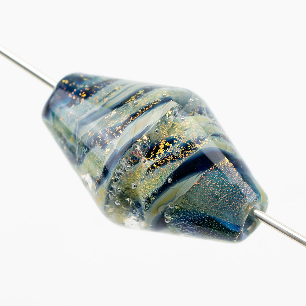 Glass bead shaped with a bicone design. Jewelry bead features a mix of green, blue, yellow, and black colors. Each side of the bead has two openings used for use in jewelry making. 