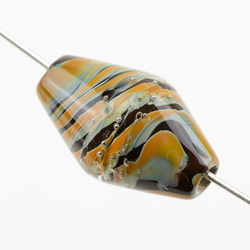 One glass bicone shaped bead looped on a metal cord. The glass bead from Unicorne beads has a swirl of orange, blue, and black, with globs of silver embedded in the middle. 